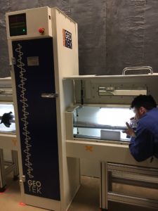 A co-op students loading and operating the XCT on a split core from 2017